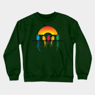 A design featuring a group of colorful birds perched on a wire, with a sunset or sunrise in the background. Crewneck Sweatshirt